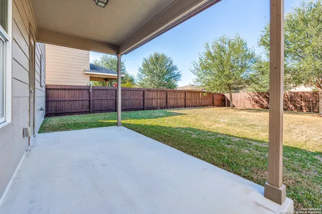 a view of a house with backyard and porch