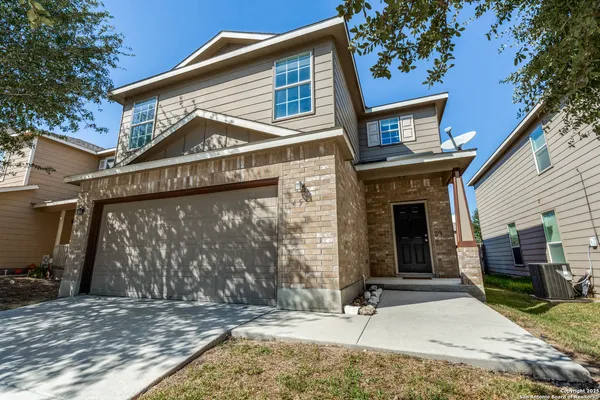 a front view of a house with garage