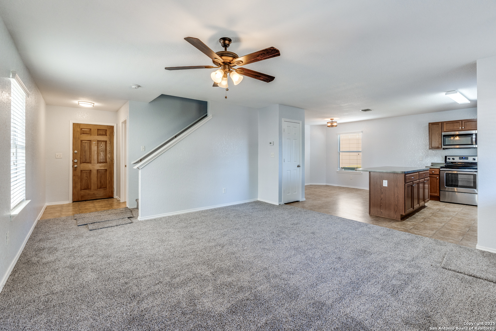 455 Walnut Crest Schertz, TX 78154 - Photo 5 of 30 a view of a livingroom with a ceiling fan and kitchen space