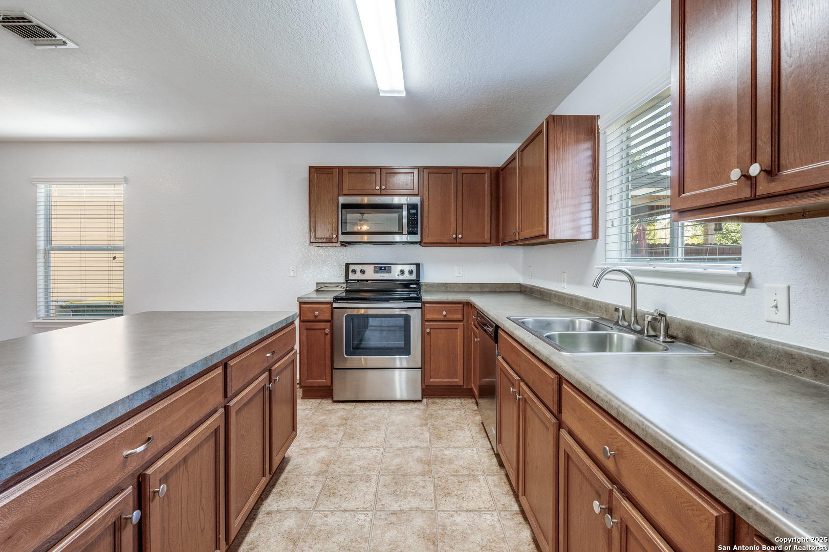 455 Walnut Crest Schertz, TX 78154 - Photo 8 of 30 a kitchen with stainless steel appliances granite countertop a sink stove and refrigerator