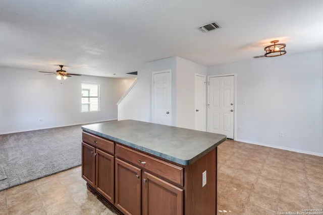 a kitchen with a sink a vanity and chandelier