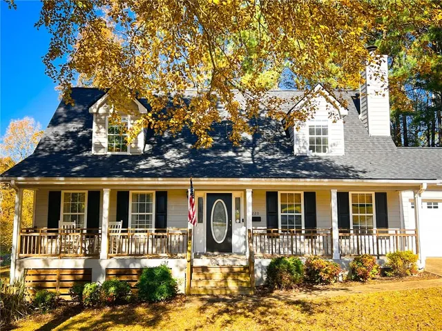 a front view of a house with yard porch and outdoor seating