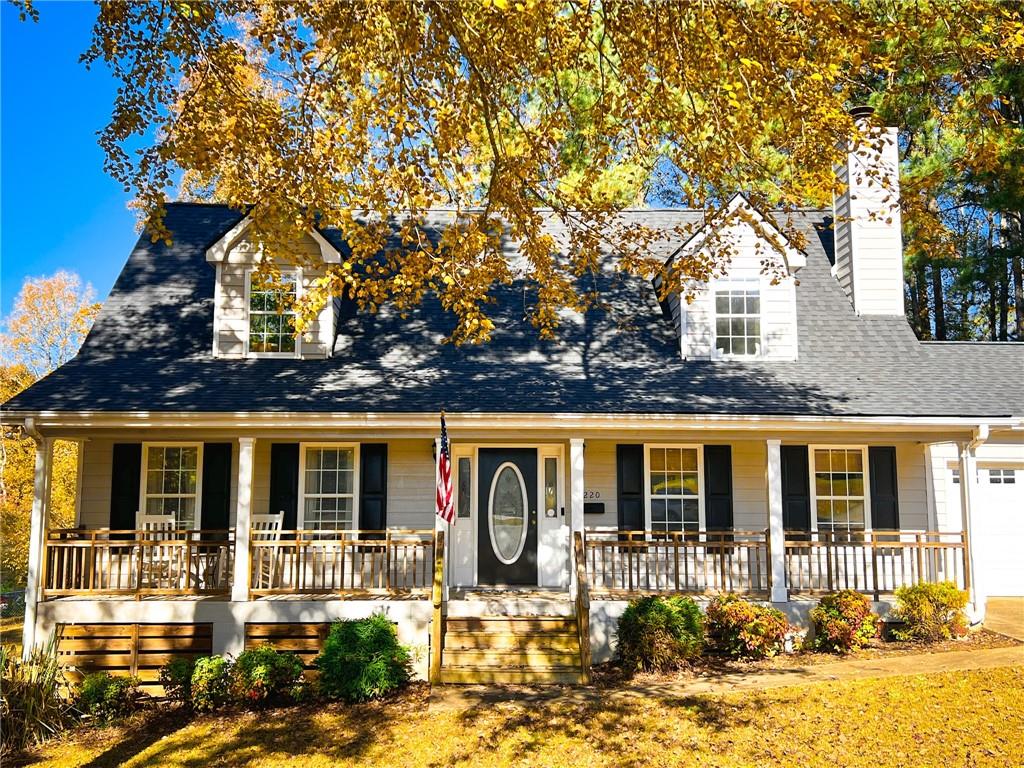 a front view of a house with yard porch and outdoor seating