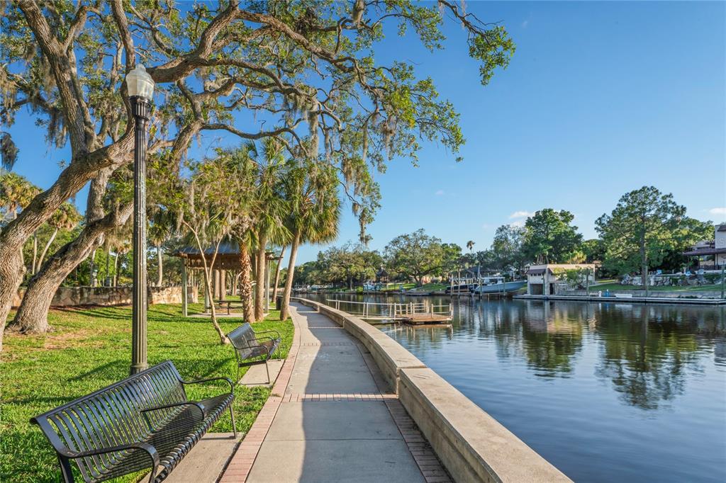 6724 Crossbow Lane New Port Richey, FL 34653 - Photo 23 of 26 a view of a lake with couches and wooden floor