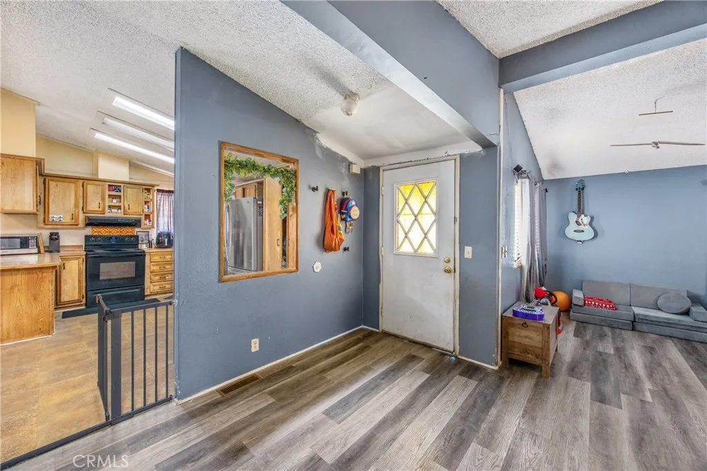 7717 Church Street, Unit 160 Highland, CA 92346 - Photo 11 of 37 a bedroom with a bed and wooden floor