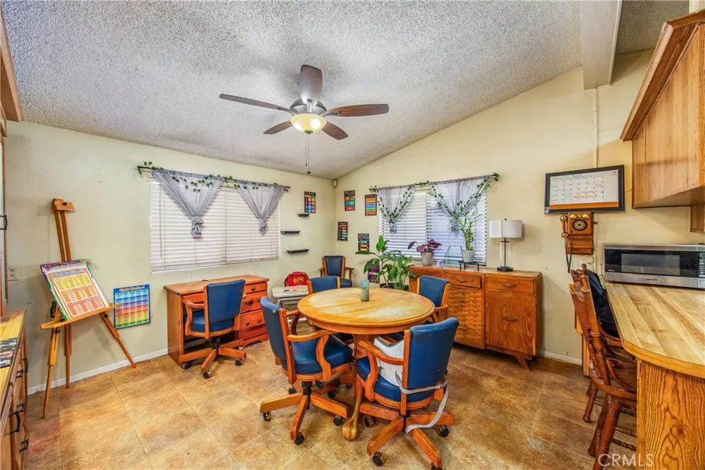 7717 Church Street, Unit 160 Highland, CA 92346 - Photo 16 of 37 a view of a dining room with furniture and a chandelier