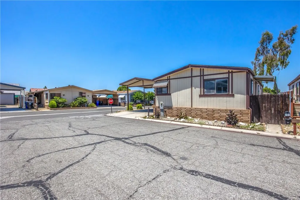 7717 Church Street, Unit 160 Highland, CA 92346 - Photo 2 of 37 a front view of a house with a yard