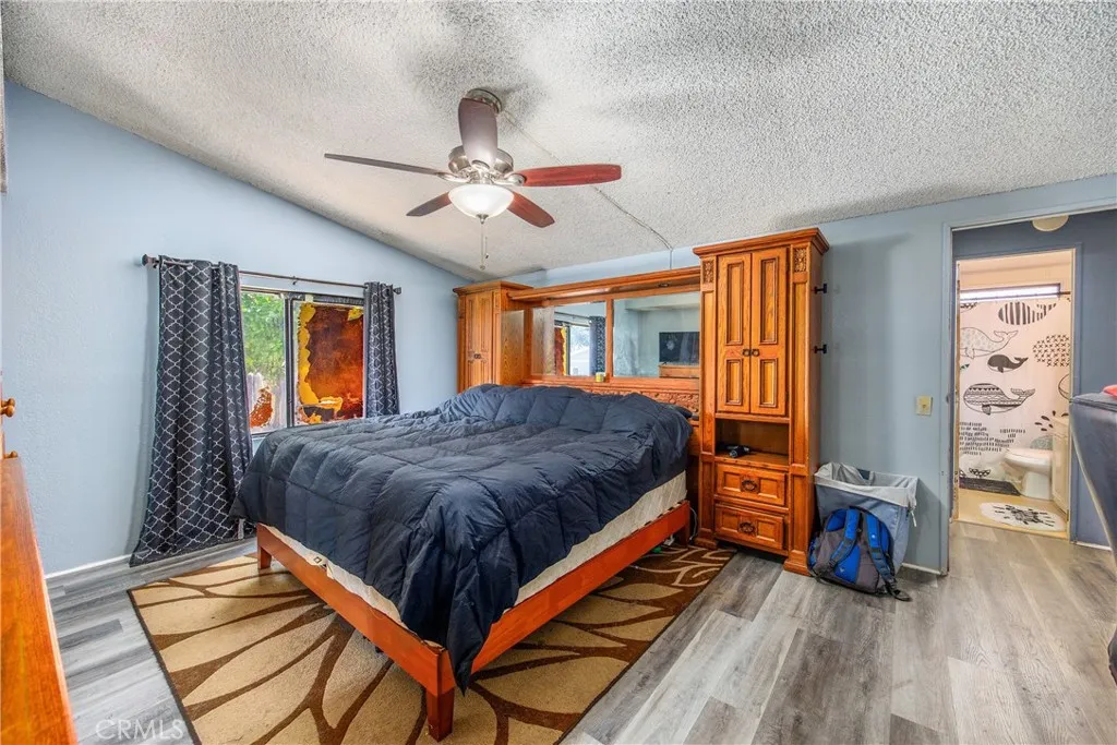 7717 Church Street, Unit 160 Highland, CA 92346 - Photo 24 of 37 a bedroom with bed and a window