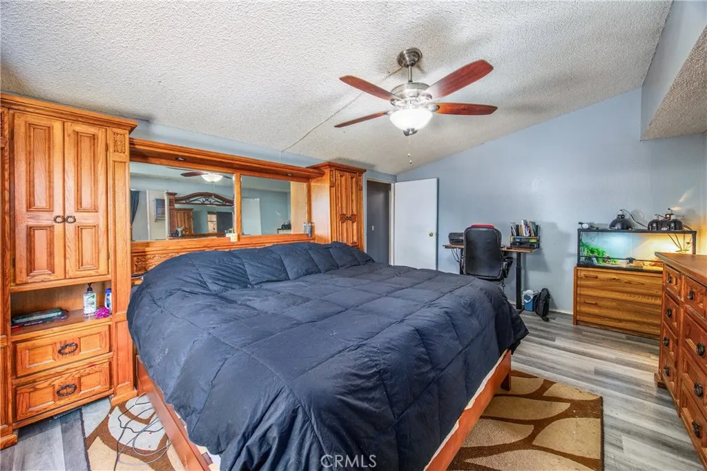 7717 Church Street, Unit 160 Highland, CA 92346 - Photo 25 of 37 a bed room with a bed and dresser