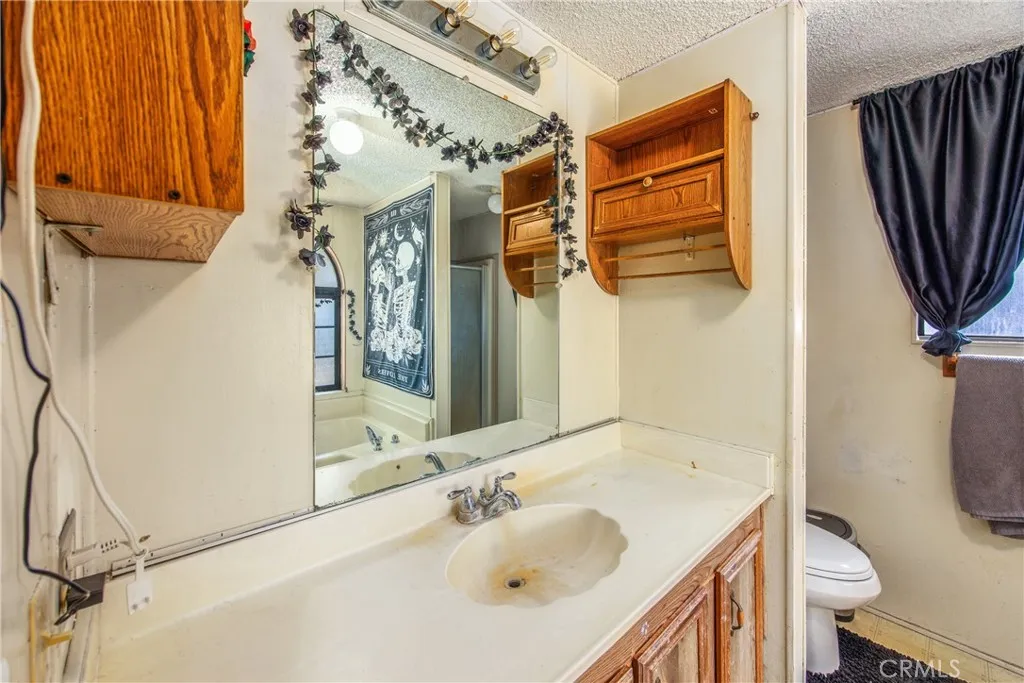 7717 Church Street, Unit 160 Highland, CA 92346 - Photo 26 of 37 a bathroom with a sink toilet and shower