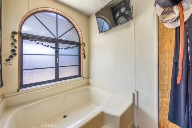 a bathroom with a bathtub and a window