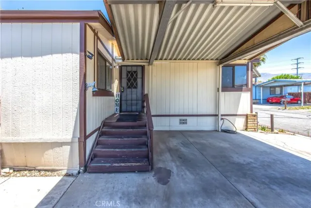 a view of an entryway with wooden floor and livingroom view