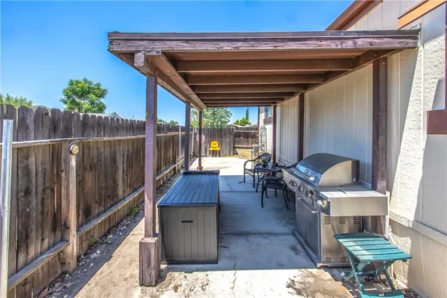 a backyard of a house with table and chairs