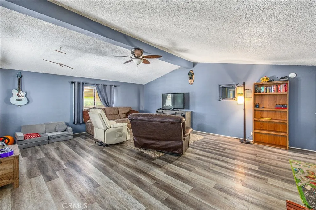 7717 Church Street, Unit 160 Highland, CA 92346 - Photo 6 of 37 a living room with furniture and a wooden floor