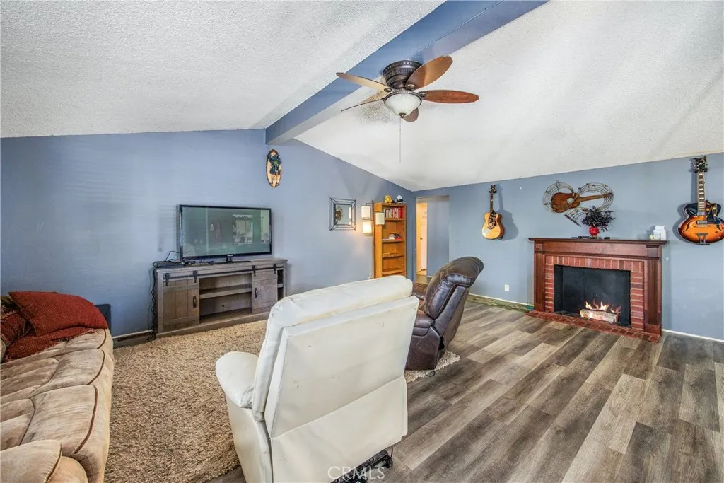 7717 Church Street, Unit 160 Highland, CA 92346 - Photo 9 of 37 a living room with furniture and a fireplace