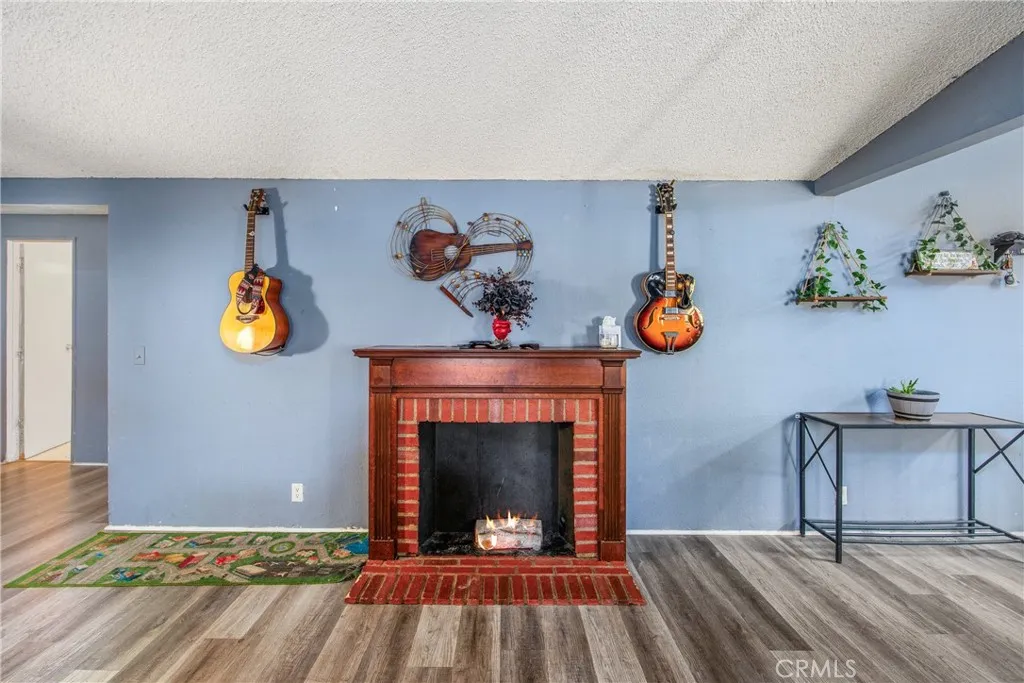 7717 Church Street, Unit 160 Highland, CA 92346 - Photo 10 of 37 a view of room with painting and wooden floor