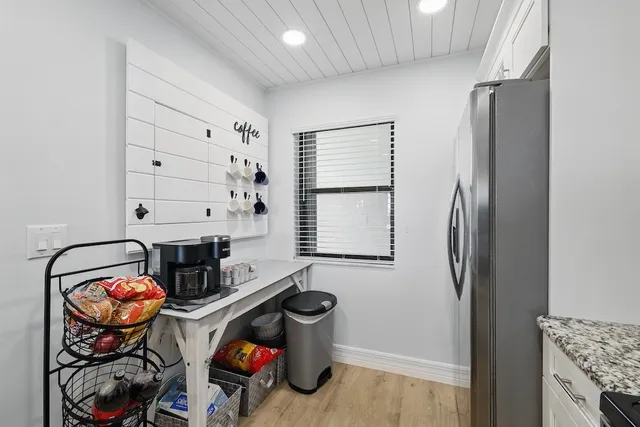 a storage room with stainless steel appliances kitchen island a stove and a refrigerator