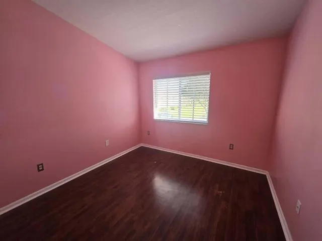 an empty room with wooden floor
