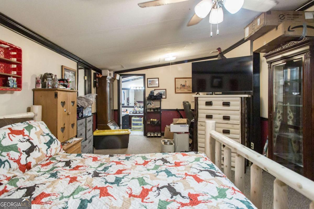 4535 Oak View Circle Waycross, GA 31503 - Photo 15 of 33 a bedroom with furniture and a flat screen tv