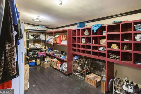a view of walk in closet with clothes and shoes