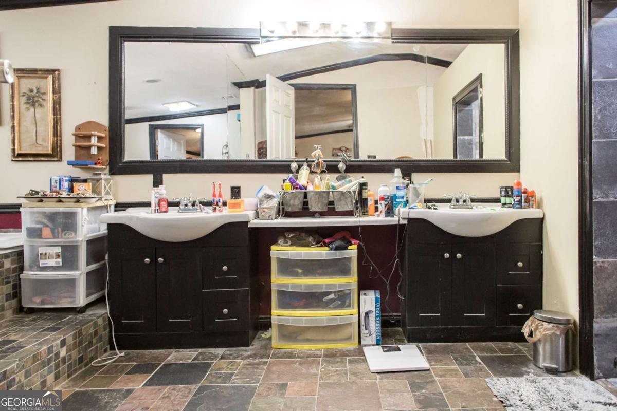 4535 Oak View Circle Waycross, GA 31503 - Photo 18 of 33 a bathroom with a sink vanity and mirror