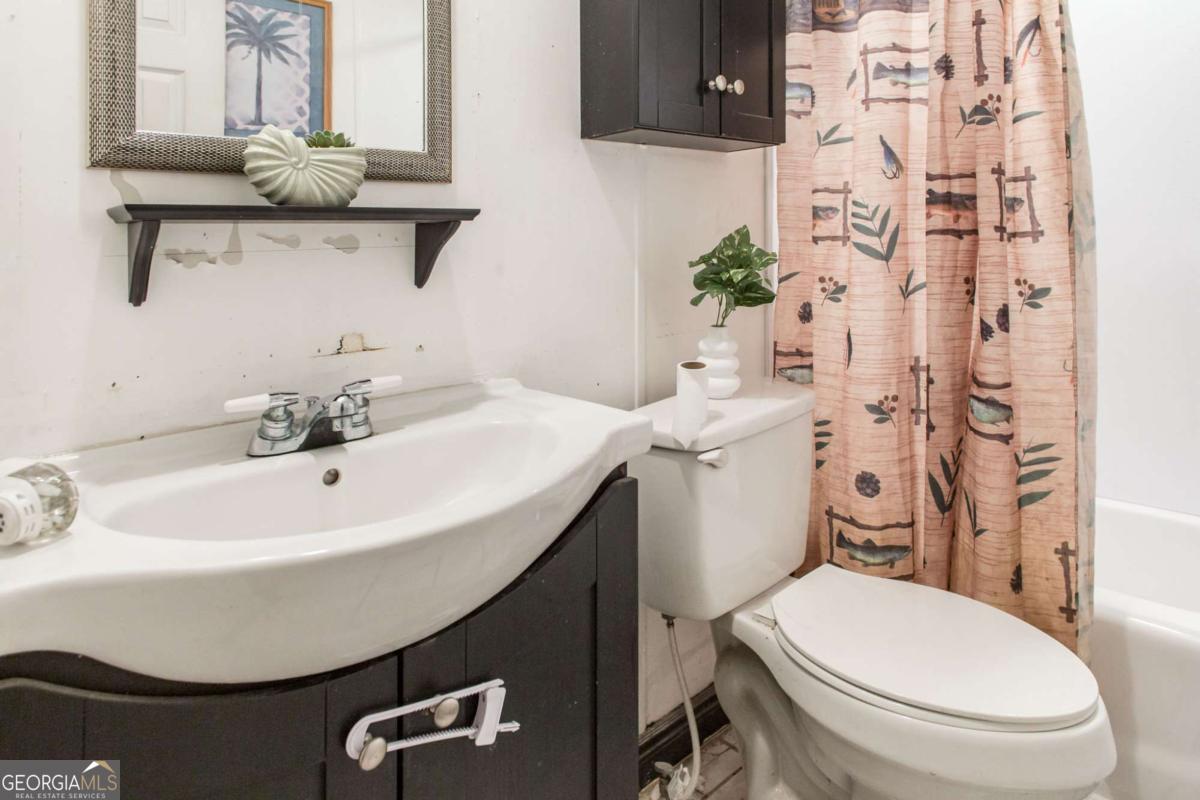 4535 Oak View Circle Waycross, GA 31503 - Photo 24 of 33 a bathroom with a sink a toilet and a mirror