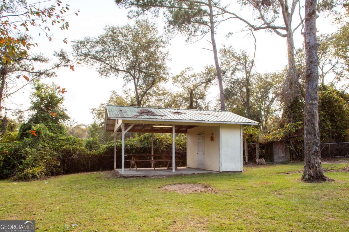 4535 Oak View Circle Waycross, GA 31503 - Photo 31 of 33 a view of a house with backyard porch and sitting area