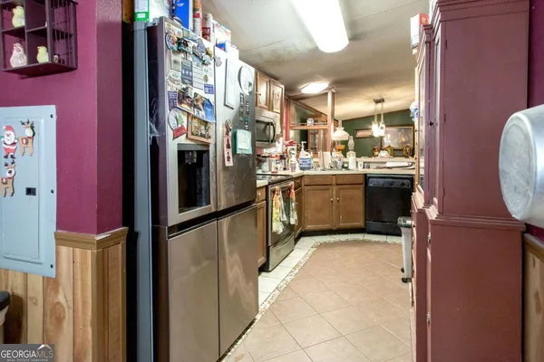 a kitchen with stainless steel appliances granite countertop a refrigerator and a stove