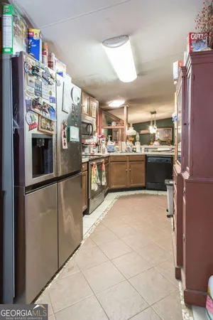 a kitchen with refrigerator and cabinets