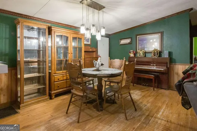 a view of a dining room with furniture and a chandelier