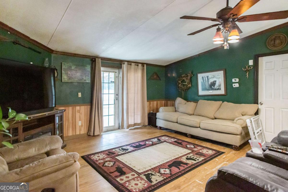 4535 Oak View Circle Waycross, GA 31503 - Photo 10 of 33 a living room with furniture and a flat screen tv