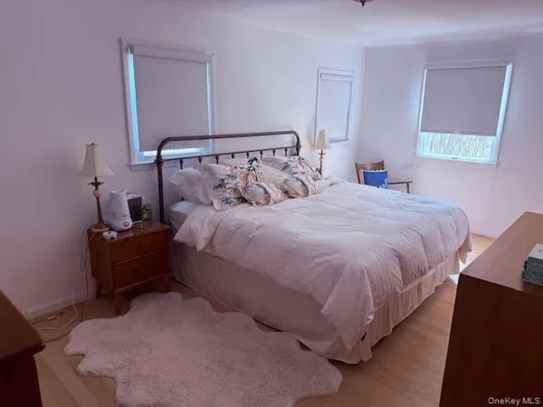 a bed room with a bed and a night stand