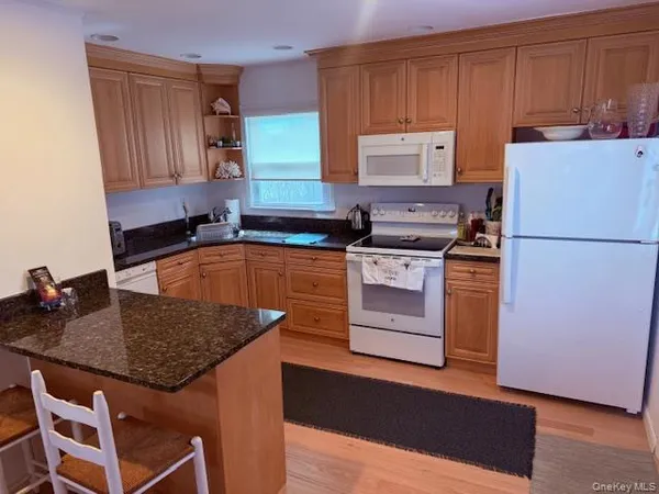 a kitchen with a stove a sink and a refrigerator