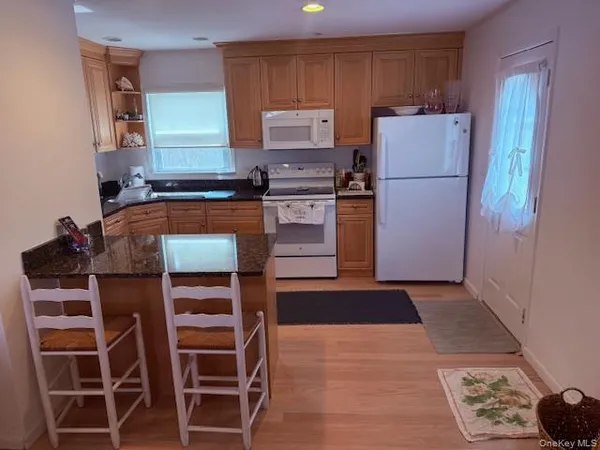 a kitchen with stainless steel appliances a stove a refrigerator and a sink