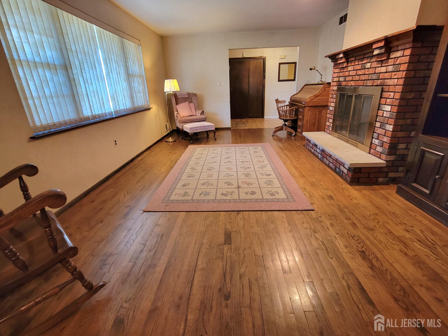 14 Perry Avenue Monroe Township, NJ 08831 - Photo 12 of 37 a living room with furniture and a wooden floor