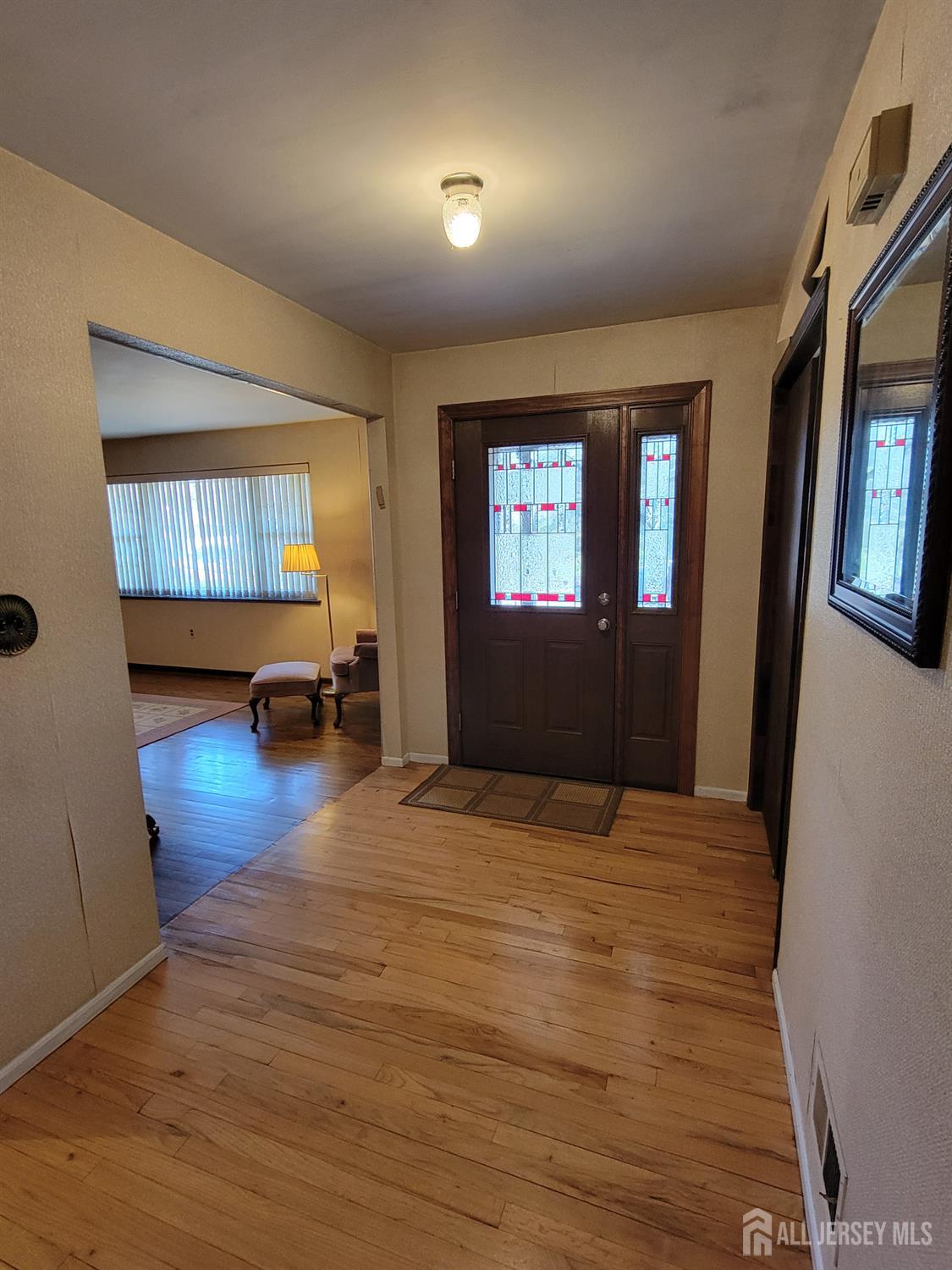 14 Perry Avenue Monroe Township, NJ 08831 - Photo 16 of 37 a view of an empty room with window and wooden floor
