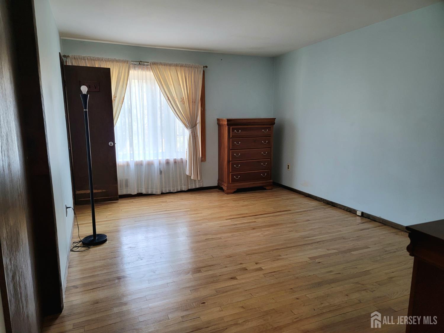 14 Perry Avenue Monroe Township, NJ 08831 - Photo 18 of 37 an empty room with wooden floor and windows