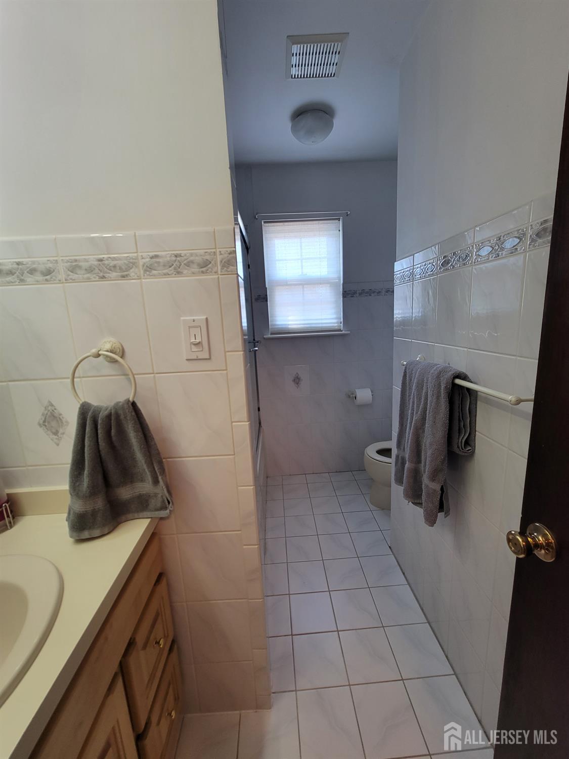 14 Perry Avenue Monroe Township, NJ 08831 - Photo 22 of 37 a bathroom with a sink and washing machine