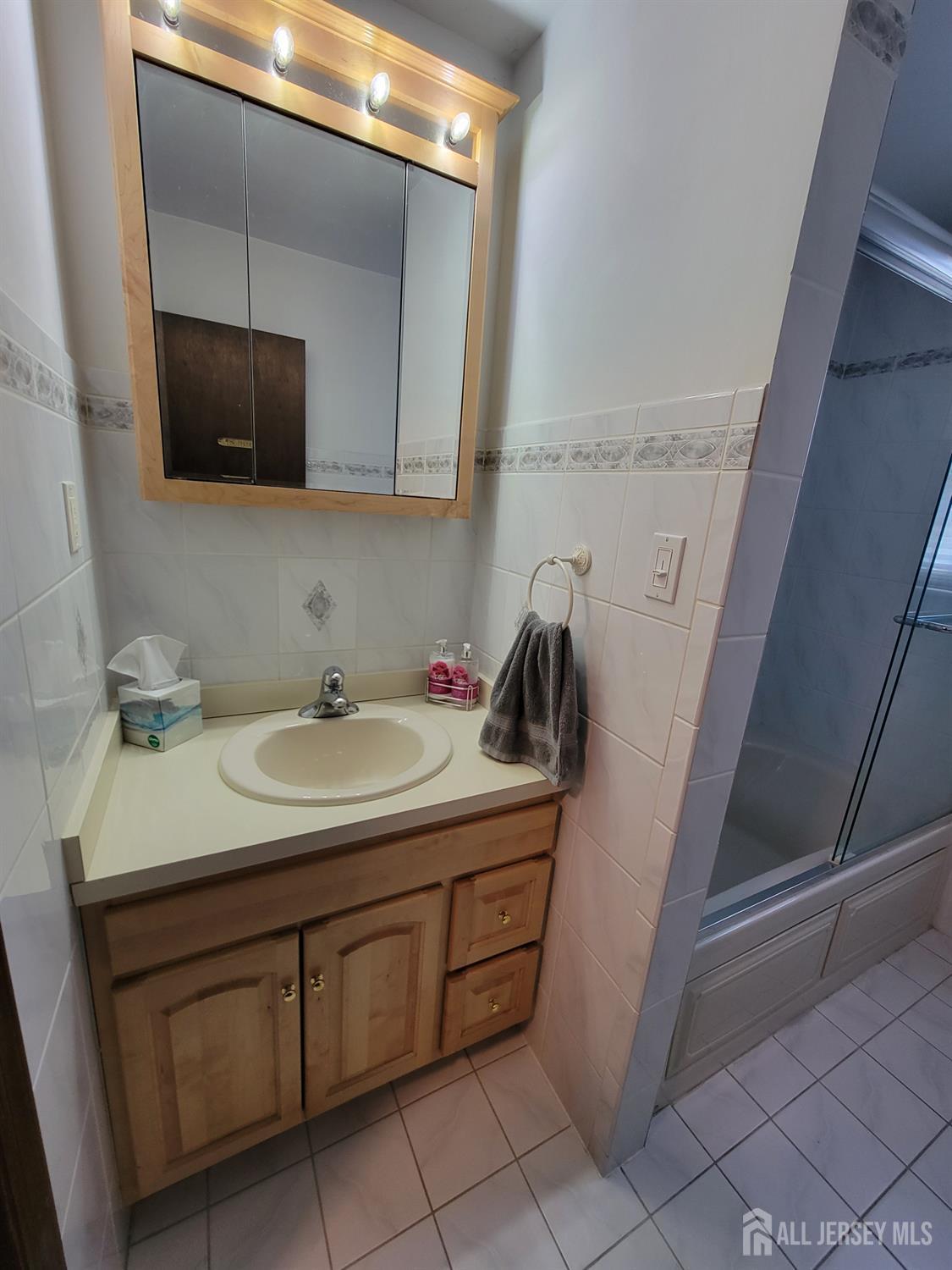 14 Perry Avenue Monroe Township, NJ 08831 - Photo 23 of 37 a bathroom with a sink and a mirror