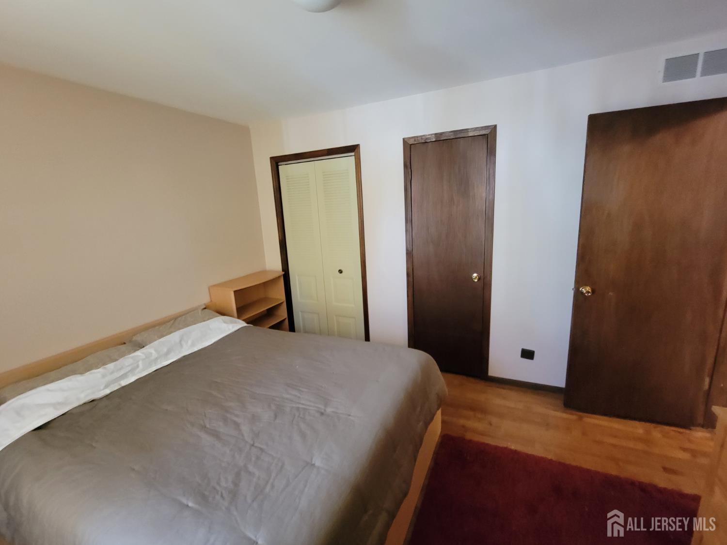 14 Perry Avenue Monroe Township, NJ 08831 - Photo 28 of 37 a bedroom with a bed and wooden floor