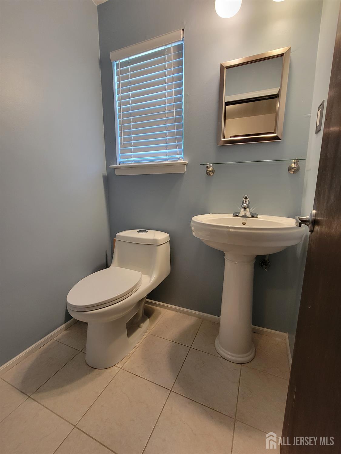14 Perry Avenue Monroe Township, NJ 08831 - Photo 30 of 37 a white toilet sitting next to a bathroom sink