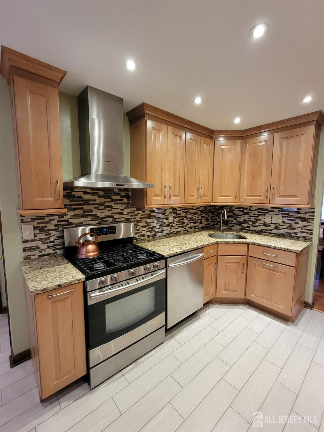 14 Perry Avenue Monroe Township, NJ 08831 - Photo 4 of 37 a kitchen with granite countertop white cabinets and white appliances