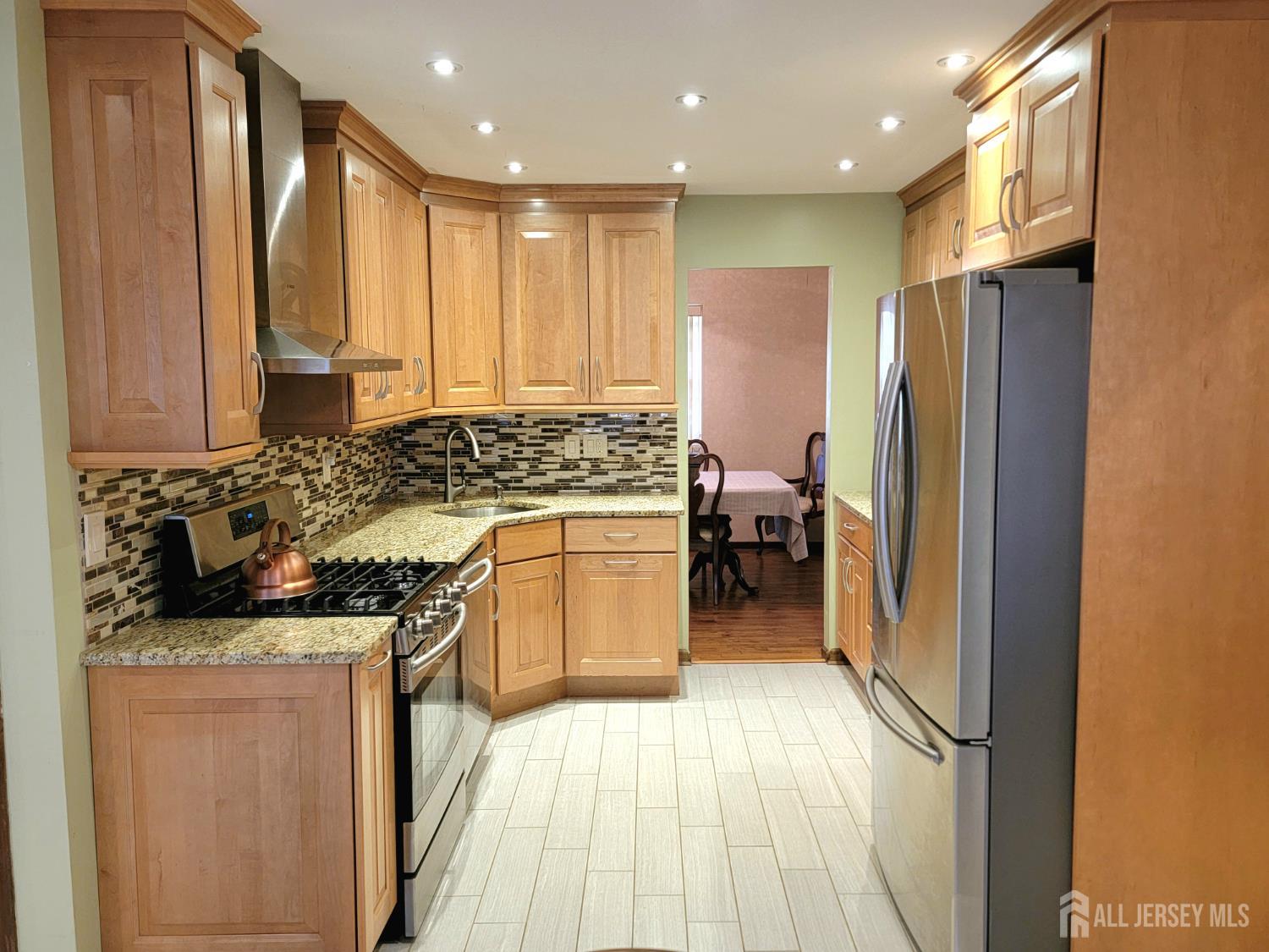 14 Perry Avenue Monroe Township, NJ 08831 - Photo 6 of 37 a kitchen with stainless steel appliances granite countertop a stove a sink and a refrigerator