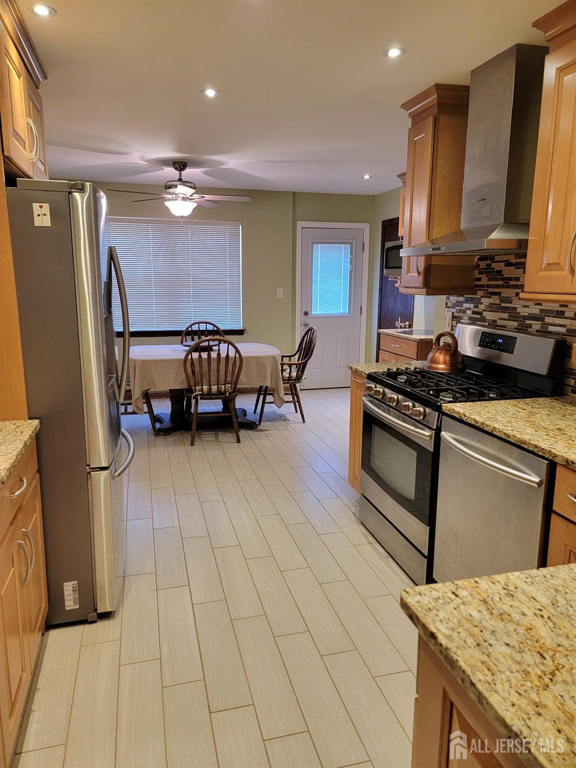 14 Perry Avenue Monroe Township, NJ 08831 - Photo 8 of 37 a kitchen with stainless steel appliances granite countertop a stove and a refrigerator