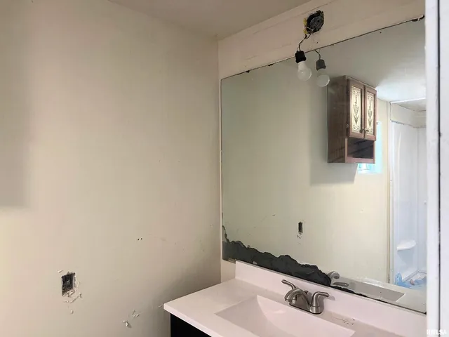 a bathroom with a sink and a mirror