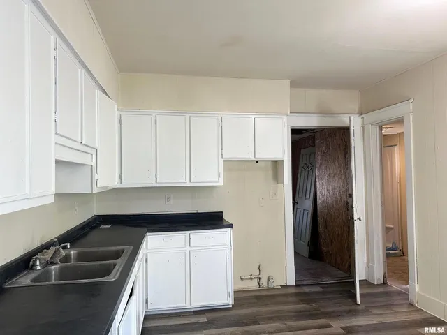 a kitchen with a refrigerator and a sink