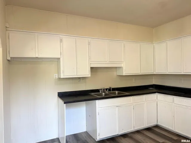 a kitchen with a sink and cabinets