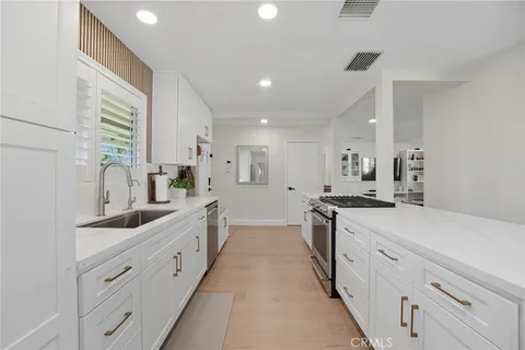 a large white kitchen with lots of counter top space