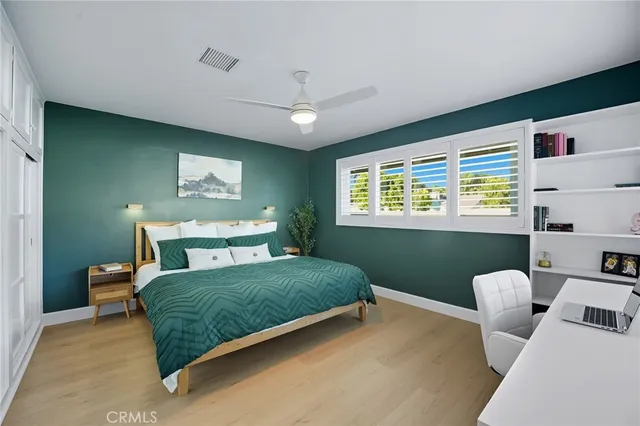 a bedroom with a bed and a window