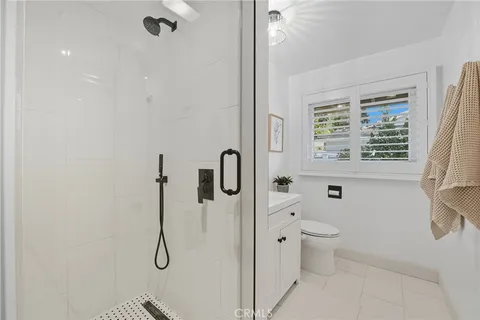 a bathroom with a sink a toilet and a window